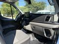 Interior of a 2022 Ford Transit showing the dashboard and driver's seat with a digital display and steering wheel