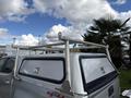 A silver 2018 Chevrolet Colorado with a metallic truck bed rack on the cab's roof