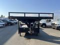 A black 2020 Load Trail 28 Foot Gooseneck trailer with a flatbed design and a hitch visible at the front