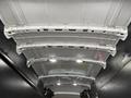 Interior view of a 2020 Ford Transit van showcasing the metal roof structure with multiple support beams and overhead lights