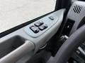 Interior view of a 2016 Peterbilt 348 showing the control panel with window switch buttons and dashboard details