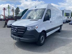 A 2025 Mercedes-Benz Sprinter van with a white exterior and black accents parked in a lot