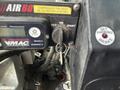 Dashboard controls of a 2012 Workhorse W62 featuring a key ignition switch a digital display panel and a parking brake indicator