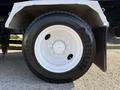 Close-up of a white tire mounted on a 2017 International 4300 truck with visible tread and shiny rim