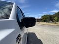 A 2021 Ford F-150 truck with side mirror visible from the driver's perspective