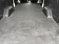 Interior view of a 2020 Ford Transit cargo area with a flat rubber floor and raised side edges designed for utility and storage