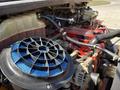 A 2011 Freightliner B2 engine with a prominent blue air filter and various hoses connecting the engine components