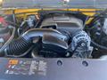 A 2013 Chevrolet Silverado 1500 engine displaying the air intake and alternator components along with various hoses and wiring