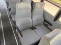 Gray padded seats from a 2009 International 3000 CE bus with seat belts and ribbed upholstery