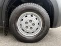 A close-up view of a black tire mounted on a silver wheel with six holes labeled as Michelin on the side