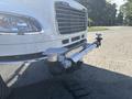 A 2022 Freightliner M2 106 with a white exterior featuring a chrome grille and a specialized front bumper with attachments for equipment or tools