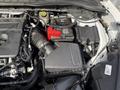 A 2020 Ford Escape engine compartment featuring the air intake, battery, and various electronic components