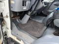 Interior view of a 2012 Mitsubishi Fuso FE showing the driver's footwell and floor mat with a focus on the steering column and dashboard area