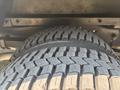 A close-up view of a tire belonging to a 2018 Ford Econoline showcasing its tread pattern and texture