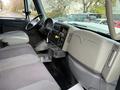 Interior of a 2011 International WorkStar truck featuring a gray dashboard and seating with a steering wheel gear shifter and controls visible