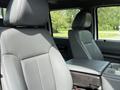 Interior view of a 2011 Ford F-350 SD featuring gray leather seats and a center console between the front seats