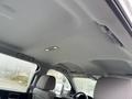 Interior view of a 2015 GMC Sierra 1500 showing the ceiling and light fixtures with overhead controls and two front seats visible in the foreground