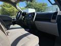Interior view of a 2018 Ford F-150 showing the driver's side with a steering wheel dashboard and front seats in gray fabric