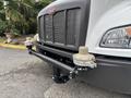 A 2025 Peterbilt 536 with a gray front grille and two circular attachments on the front bumper