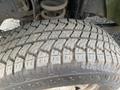 Close-up of a heavily treaded tire from a 2014 Ford F-350 SD showcasing deep grooves and rugged texture designed for off-road performance