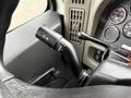 A close-up of the turn signal lever inside a 2014 International 7500 with various control indicators visible on the dashboard