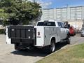 A 2021 RAM 5500 truck with a white exterior and a black flatbed rear end visible from a side angle