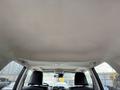 The interior ceiling of a 2021 Toyota 4Runner with a light-colored fabric material and recessed lighting fixtures