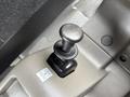 A black gearshift knob labeled OFF and PARK situated on a beige console within a vehicle