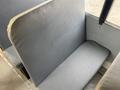 A gray vinyl seat from a 2013 International 4300 bus with a simple design and smooth surface