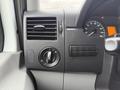 Close-up of the dashboard controls in a 2016 Mercedes-Benz Sprinter featuring air vents light controls and a digital speedometer