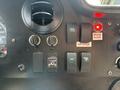 Dashboard of a 2018 Ford Econoline featuring various switches and indicators including lights fans and door ajar warning lights