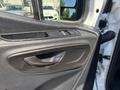 Interior door handle and controls of a 2019 Mercedes-Benz Sprinter with a dark panel and silver accents