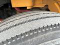 Close-up of a worn tire on a 2007 Freightliner B2 showing visible tread wear and grooves