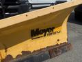 A yellow Meyer Super V2 snow plow blade with noticeable wear and rust detailing