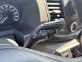 A close-up view of the multifunction lever on the steering column of a 2025 Ford Transit T-350 showing controls for turn signals and wipers
