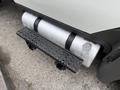 Close-up of a silver fuel tank mounted on a black step for a 2012 International TerraStar vehicle