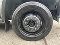 A close-up of a 2010 Ford F-550 Super Duty wheel showcasing the dark rim and tire tread with visible wheel bolts