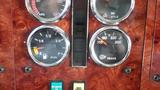The dashboard of a 2003 International 5600i displaying various gauges for fuel level transmission and warning lights