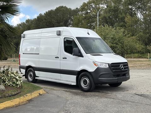 A 2020 Mercedes-Benz Sprinter 2500 van in white with a black lower section and side mirrors, featuring high roof and rear doors