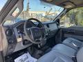 Interior view of a 2011 Ford F-550 showing the steering wheel dashboard and front seats