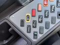 Control panel of a 2011 Freightliner B2 featuring various switches in different colors including yellow and orange along with black switches for different functions