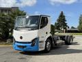 A 2022 Lion Lion6 electric truck with a white and blue exterior featuring a modern design and an exposed chassis without a cargo bed