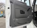 Interior door panel of a 2013 International Workstar 7500 featuring a handle and a smooth gray finish