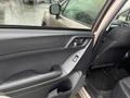 A 2016 Subaru Forester interior door panel featuring a black handle and window controls