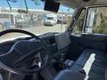 Interior view of a 2008 International DuraStar with a black steering wheel and dashboard displaying various controls and a monitor on the windshield