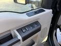 Close-up of the driver's side door panel of a 2008 Ford F-550 featuring window controls and a lock switch