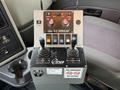 Control panel for a 2012 International 7400 with joystick levers buttons and warning labels