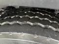 Close-up of a heavy-duty tire tread showing a robust and worn pattern typical of a 2016 International 7400 truck