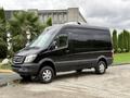 A black 2017 Mercedes-Benz Sprinter van parked at an angle with large wheels and a sleek design