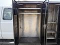 A 2008 Ford F-450 SD with open compartments revealing storage space inside the vehicle